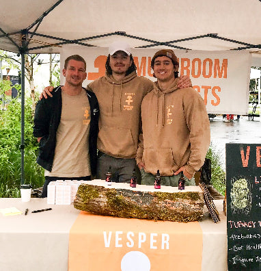 vesper mushrooms founders under a tent with 'Vesper' branding at an outdoor event here in the usa.