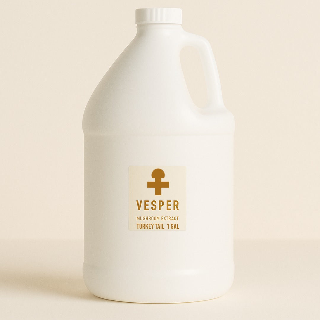 White bottle of Vesper mushroom extract on a beige background Bulk_Mushroom_extract_turkey_tail_1_gallon